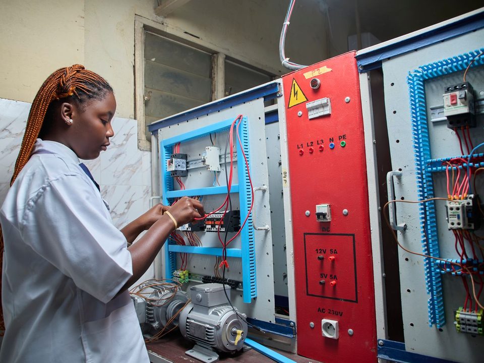 Technician wiring an industrial control panel